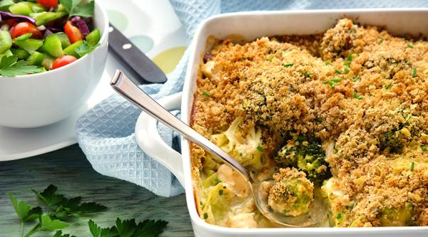 A vegetarian gratin with broccoli and a salad on the side