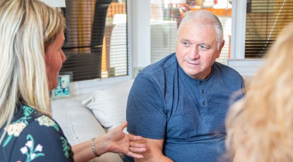 Service user and Dementia Adviser talking while seated on a sofa